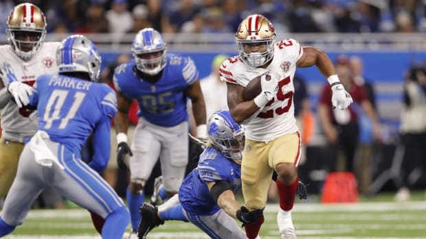 Sep 12, 2021; Detroit, Michigan, USA; San Francisco 49ers running back Elijah Mitchell (25) runs past Detroit Lions middle linebacker Alex Anzalone (34) during the fourth quarter at Ford Field. Mandatory Credit: Raj Mehta-USA TODAY Sports